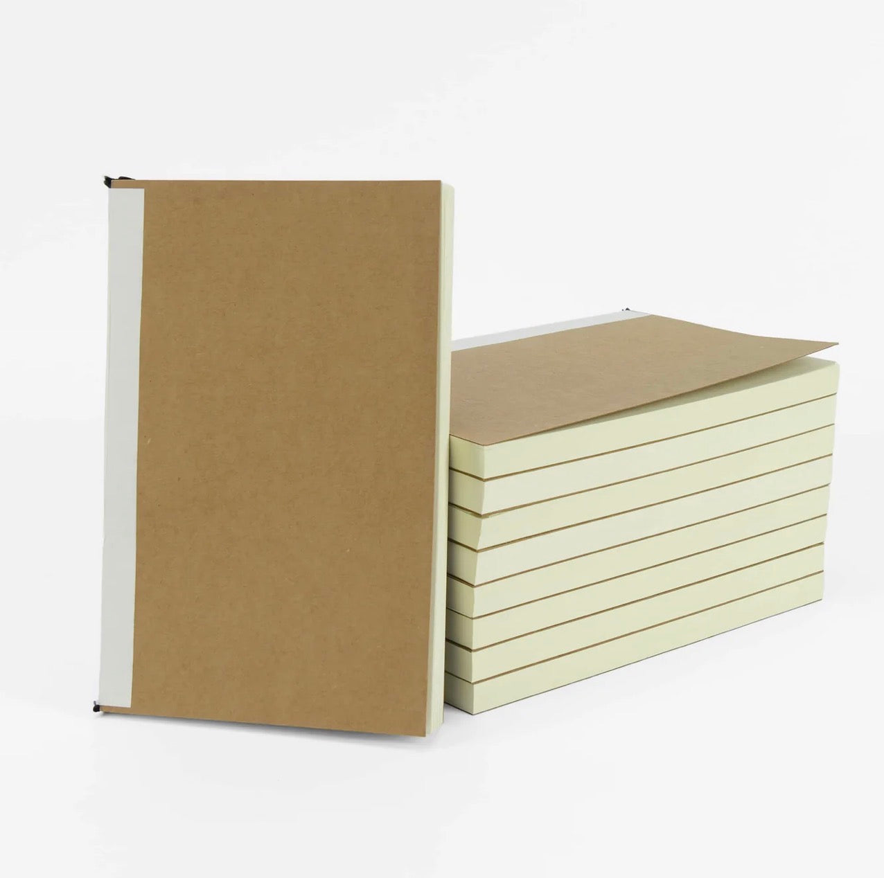 Two notebooks, one brown and one beige, on a white background