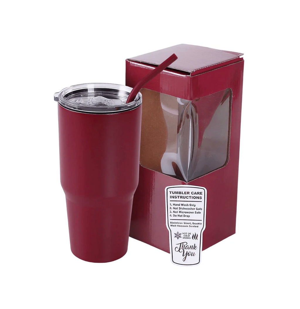 A dark red insulated tumbler with a clear lid and matching red straw, shown next to its branded retail box on a white background.