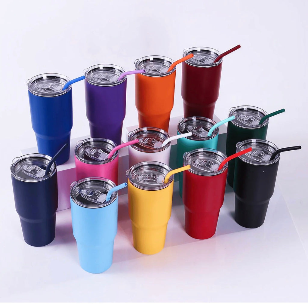 A group of insulated stainless steel travel tumblers in assorted colors, each with a matching straw and a clear lid, arranged on a white studio background.